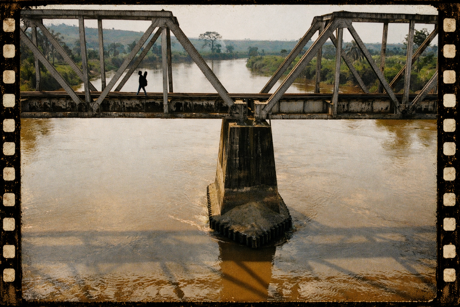 Silhouette on bridge over river