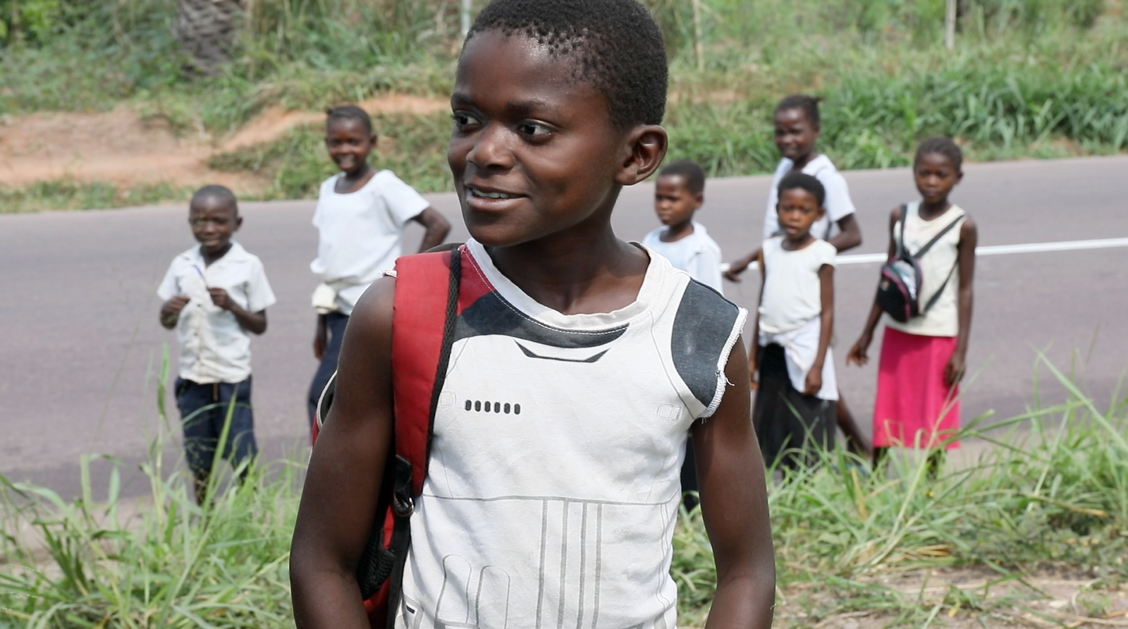 Children walking along a road in Congo