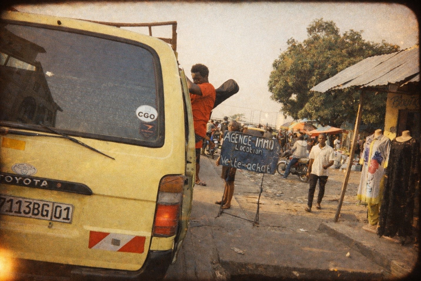 Street scene in Kinshasa with yellow van